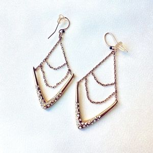 Alexis Bittar diamond shaped earrings with crystal and chain details.